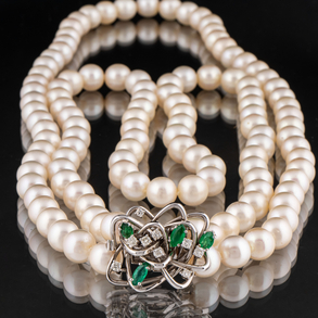 Beautiful two strand cultured pearl necklace with 18kt white gold clasp with navet cut emeralds and diamonds.