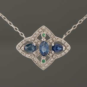 18kt white gold chain with a pendant of three sapphires, two emeralds and diamonds.