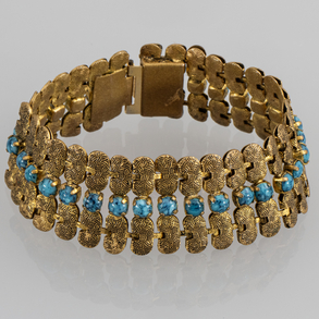 Wide gold plated metal bracelet with turquoise stone beads.