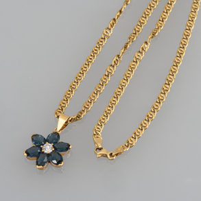 18kt yellow gold link chain with flower shaped pendant with blue crystals.