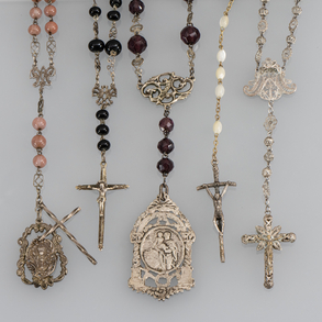 Set of five silver rosaries with faceted stones.
