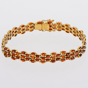 Bracelet in 18kt yellow gold with red stones.