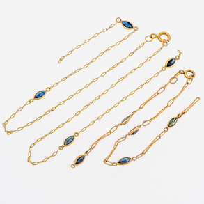 Chain and bracelet set in 18kt yellow gold with blue crystals.