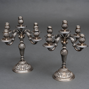Pair of five lights candlesticks in Spanish silver embossed and punched 20th century.
