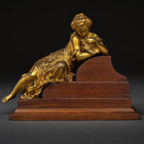 “Reclining lady with bird” 19th century gilt bronze figure.
