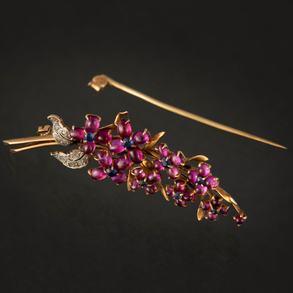 18kt yellow gold branch pin with sapphire and rubies.