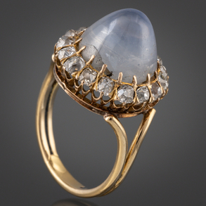 18kt yellow gold ring with a moonstone bordered with diamonds.