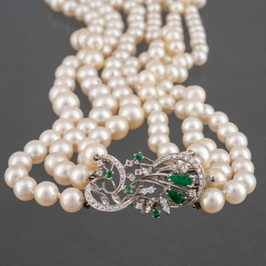 Three strand pearl necklace with 18kt white gold clasp with diamonds and emeralds.