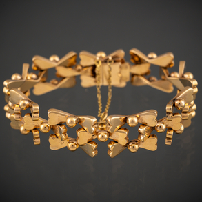 Wide articulated bracelet with openwork elements in 18kt yellow gold.